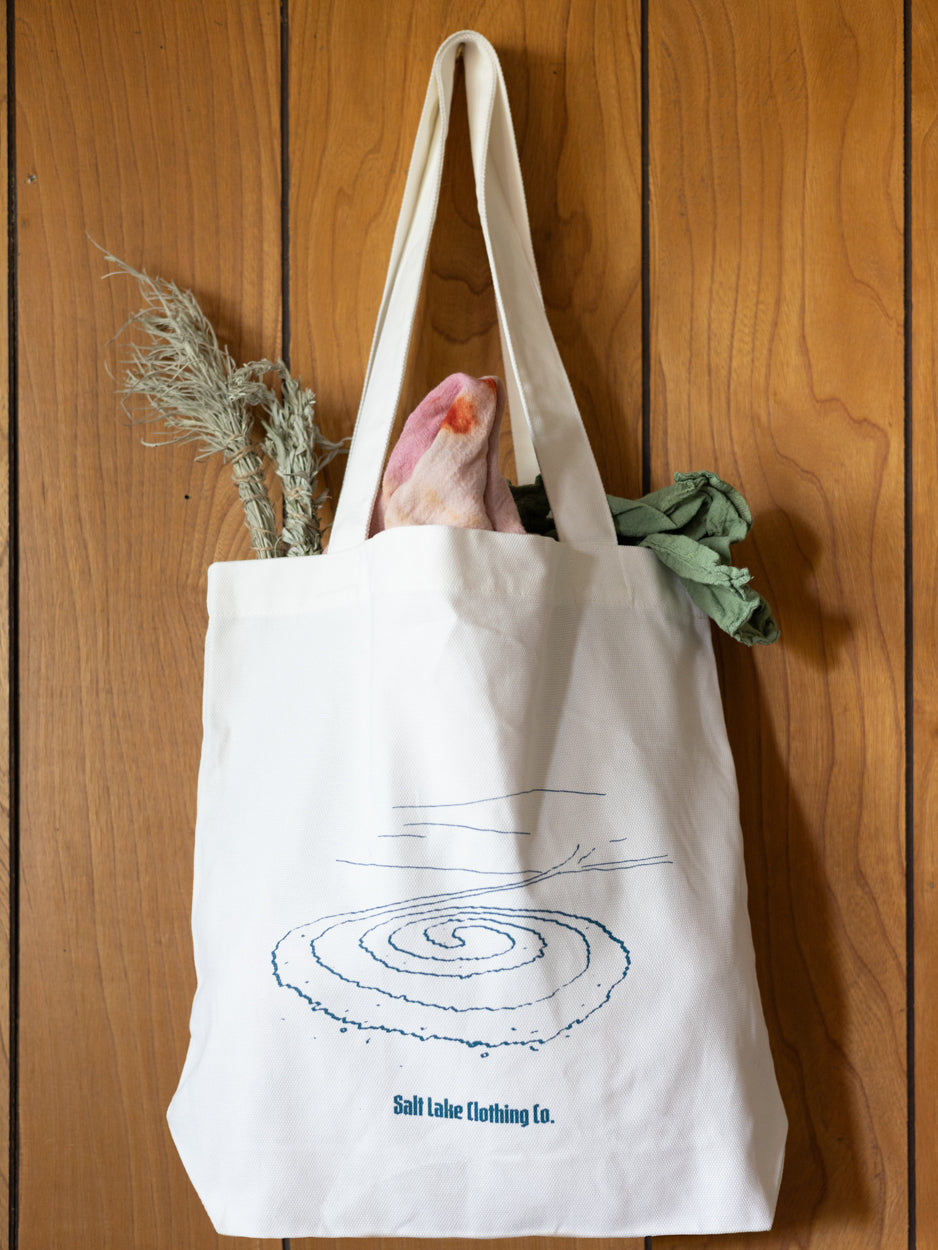 Close-up of Salt Lake Clothing Jetty Tote, it is carrying dried flowers, hand dyed fabrics, and art supplies.